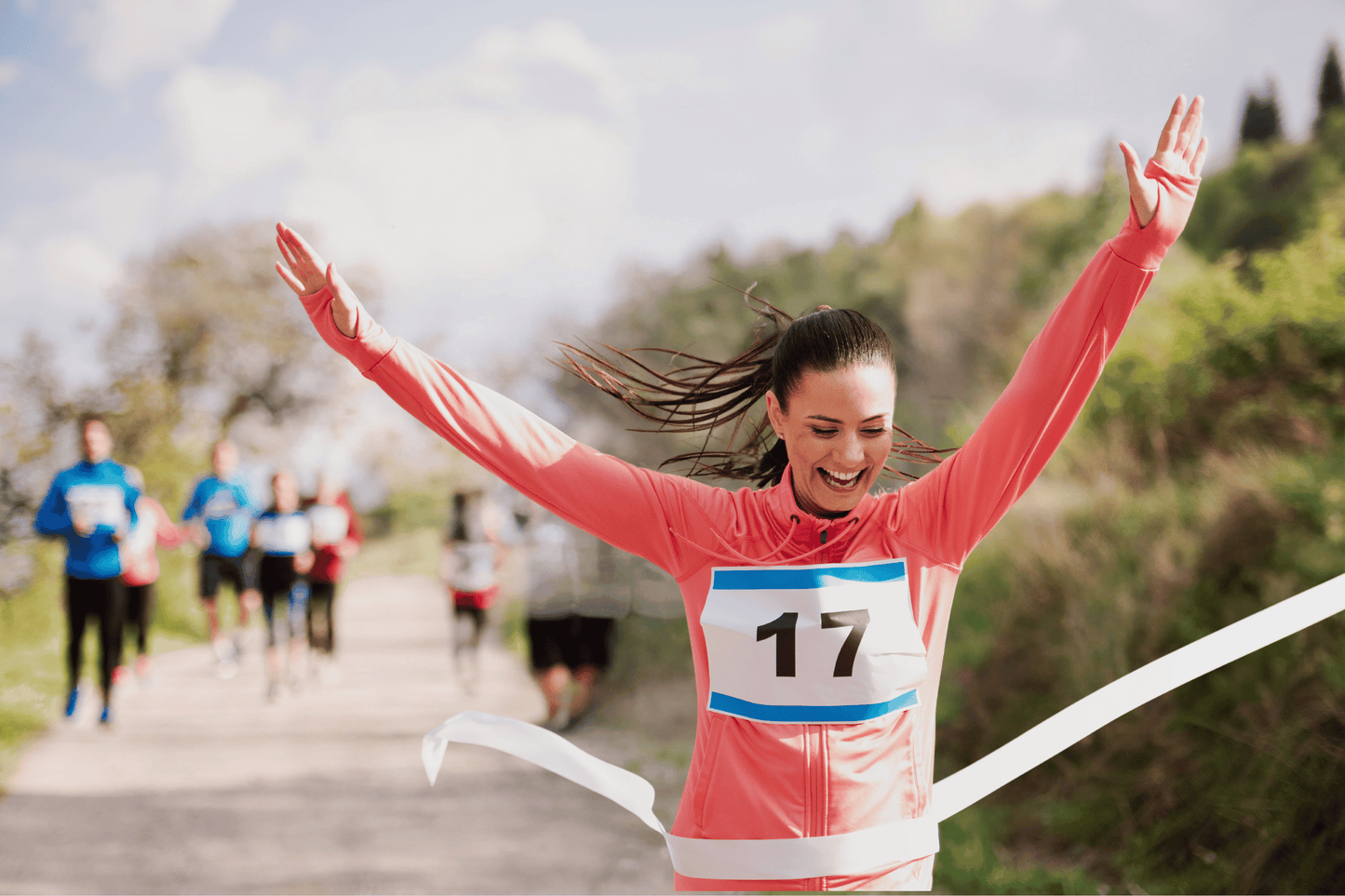 A woman crossing the JM Band NO Målgangsbånd i farger på lager finish line of a race.