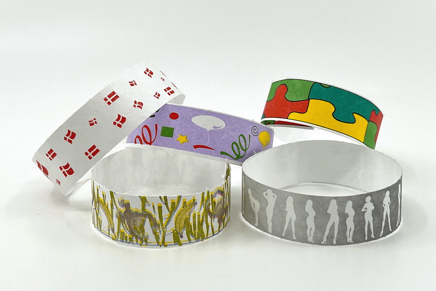 En gruppe Papirarmbånd med mønster På lager fra JM Band NO med forskjellige design på.