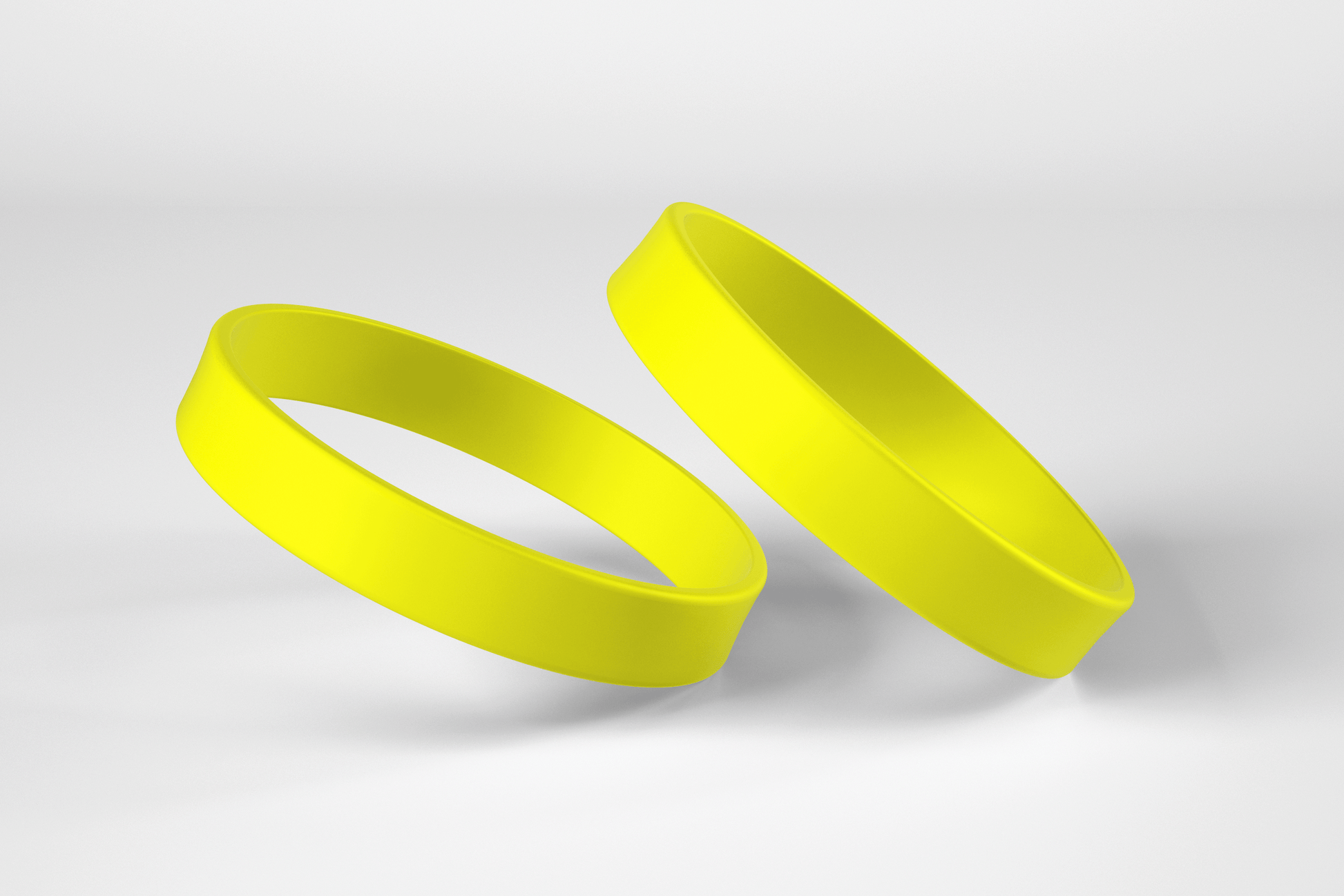 To gule JM Band NO silikonbånd på hvit bakgrunn.
