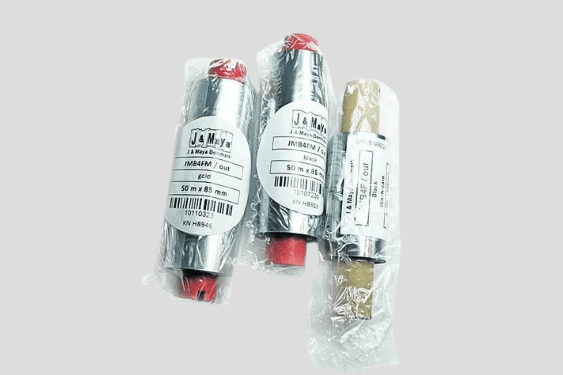 Tre JM Band NO plastpakker med røde og hvite etiketter på, som inneholder Folier for termiske overføring FZ.