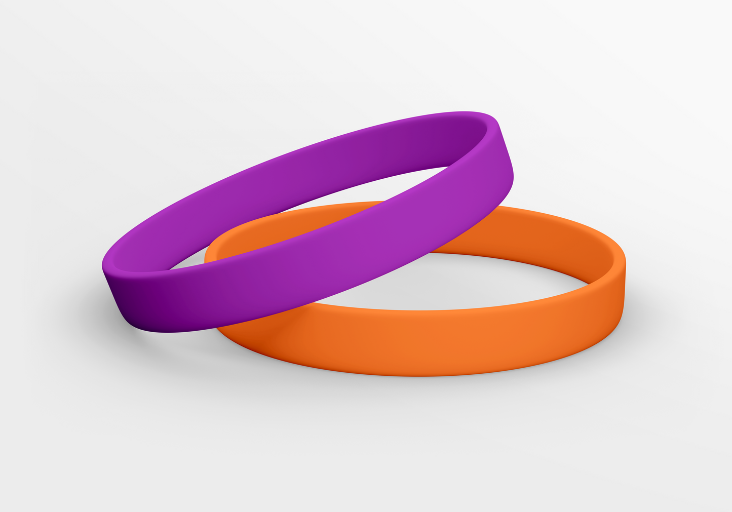 Et par lilla og oransje Silikonarmbånd uten trykk på hvit bakgrunn. (JM Band NO)